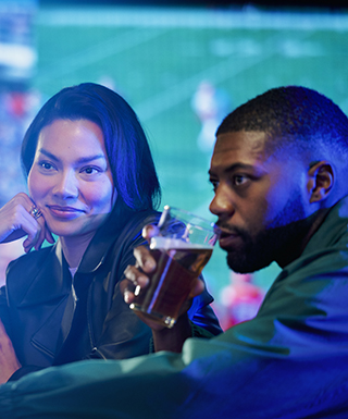 couple watching game on the big screen