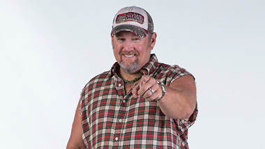 A photo of Larry The Cable Guy pointing at the camera.