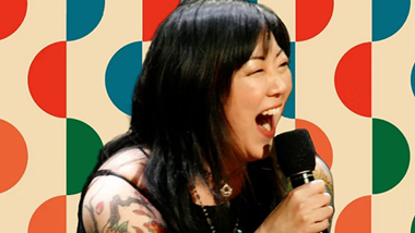Margaret Cho laughing with dots in the background