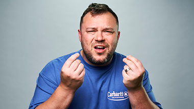 Ben Bankas in blue shirt with gray background