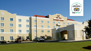 Front view of the Inn at Charles Town during the day with a TripAdvisor certificate of excellency logo.