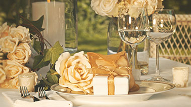 Event table with gold accents and wine glasses
