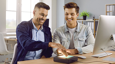 Two guys using a digital finger print service